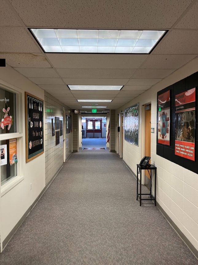 Brightly lit school hallway at Brentwood Middle School, showcasing energy-efficient LED lighting retrofitted by Colorado Controls