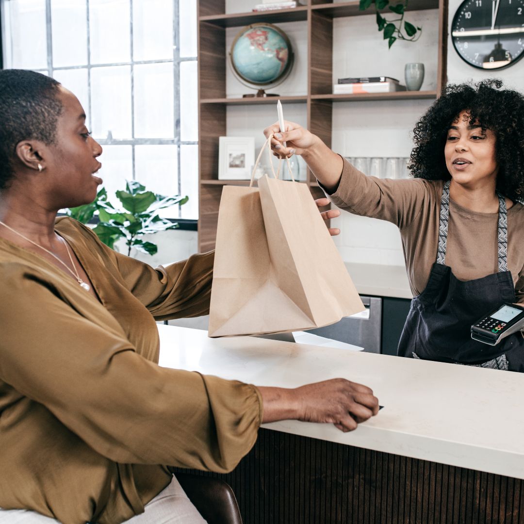 Two people making an exchange at a retail store
