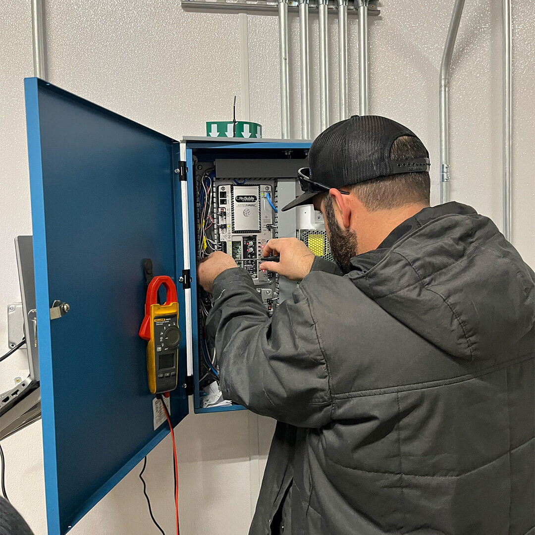 A dedicated professional building automation technician working on a system